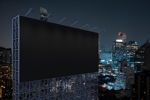 Blank black road billboard with Bangkok cityscape background at night time Street advertising poster mock up 3D rendering Side view The concept of marketing communication to promote idea