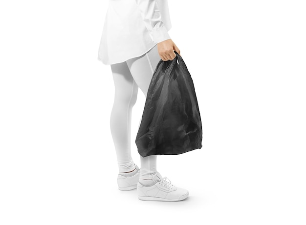 Blank black t-shirt plastic bag holding hand