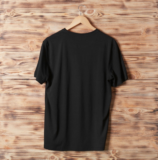 Blank black tshirt against wooden background