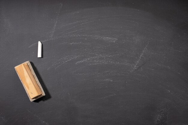 Photo blank blackboard or chalkboard with eraser and chalk for background black texture for add text or graphic design