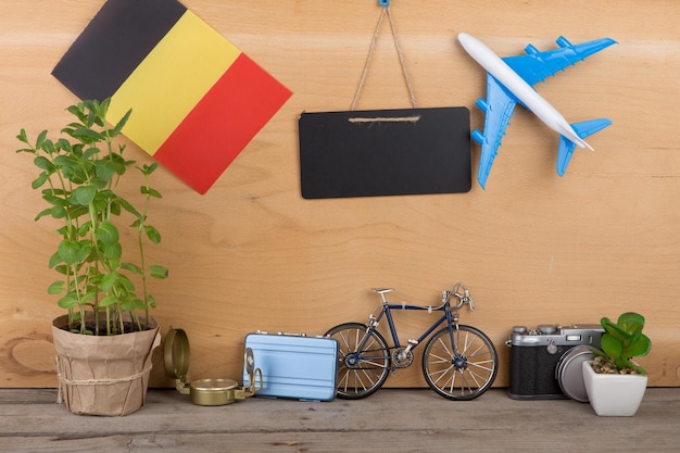 Blank blackboard flag of the Belgium airplane model little bicycle and suitcase camera compass