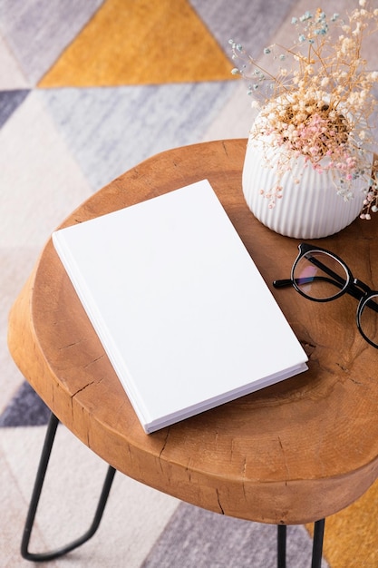 Photo blank book mockup on coffee table with decoration flowers and colorful rug