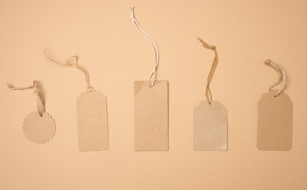 Blank brown rectangular, round brown paper tag on a rope isolated on white background, template for price, discount