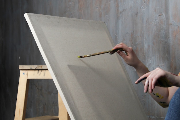 Blank canvas on an easel and brush