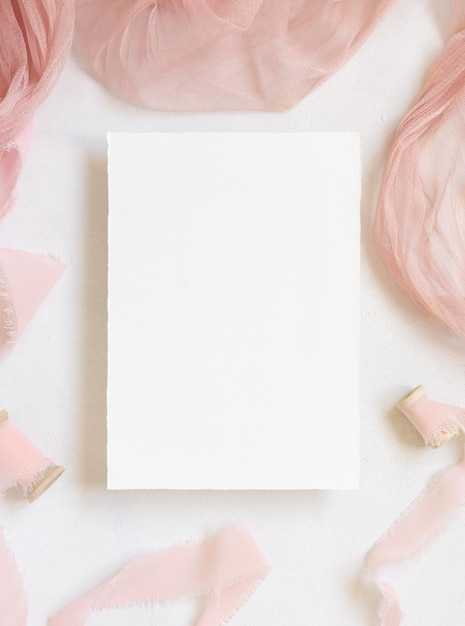 Blank Card on table with pink flowers and ribbons