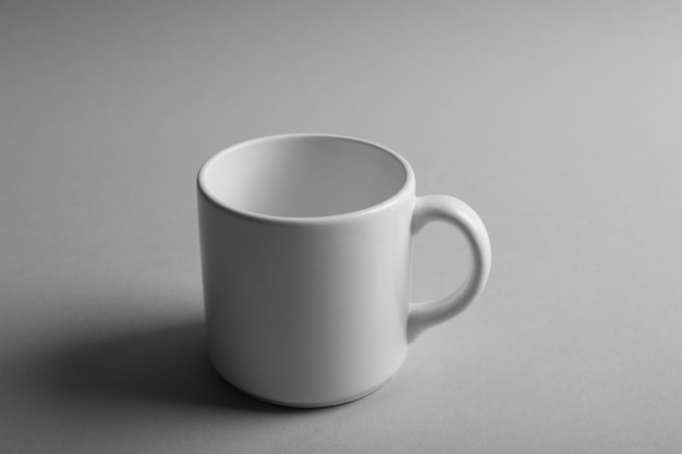 Blank ceramic cup on grey background