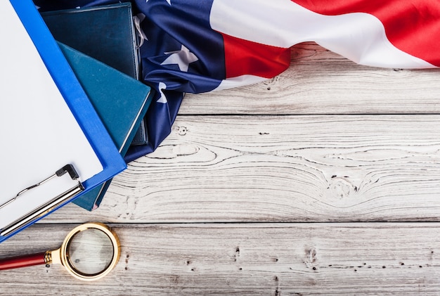 blank clip board and USA flag on wooden background