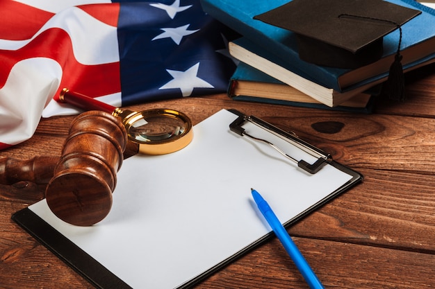 blank clip board and USA flag on wooden table