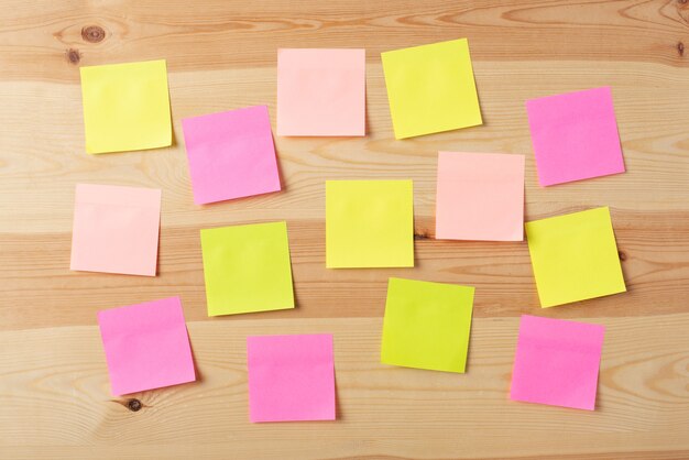 Blank colorful papers on a wooden board