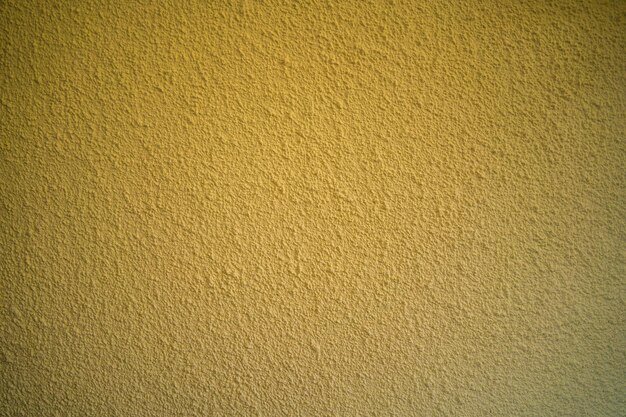 Blank concrete wall yellow color for texture background New surface looks rough Wallpaper