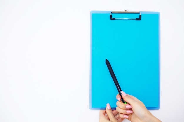 Blank Folder with Blue Paper, Hand that Holding Folder and Pen on White