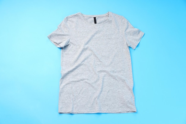 Blank gray t-shirt with space for print on blue background