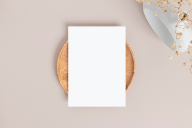 Blank greeting card invitation Mockup 5x7 on envelope with dry flowers and ribbon on paper background flat lay mockup