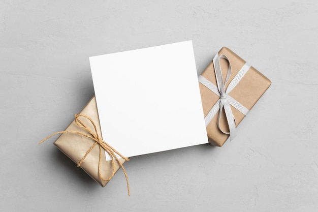 Blank greeting card mockup with gift boxes