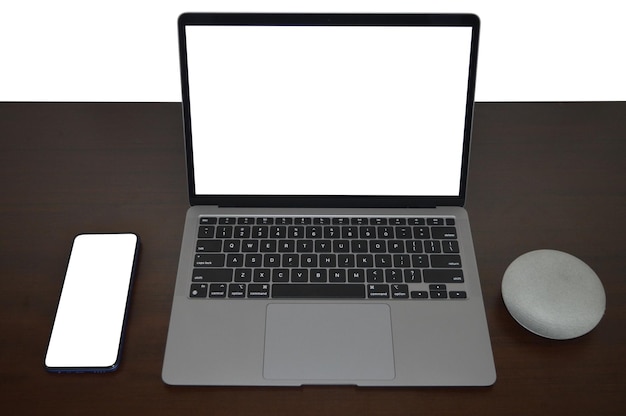 Blank laptop and mobile with speaker arrangement on wooden table