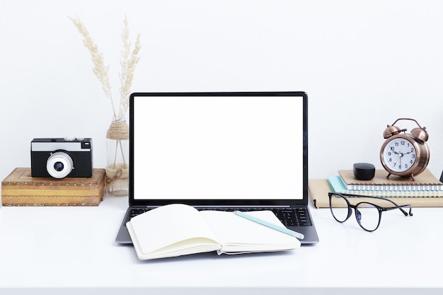 Blank laptop screen mockup, vintage camera and glasses. Work online, quarantine study, freelancer concept