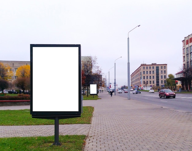 Blank mock up of vertical street poster billboard on city background