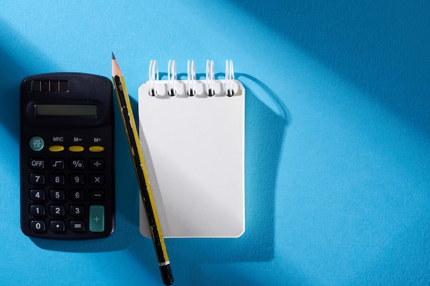 Blank note pad pencil and calculator