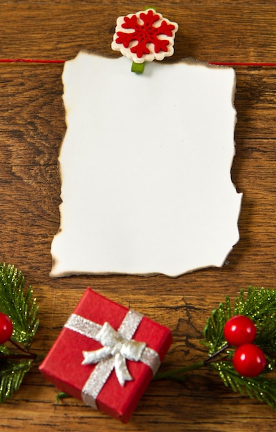 Blank note with christmas decoration on wooden background