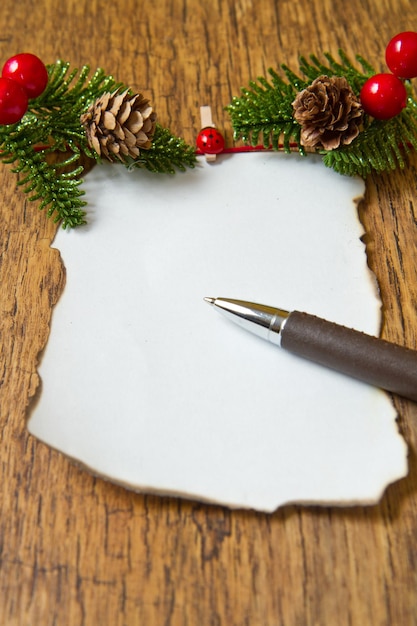 Blank note with christmas decoration on wooden background