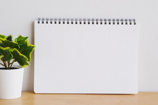 Blank notebook paper on white table background