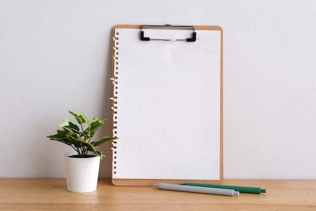 Blank notebook paper on wooden table background mock up template