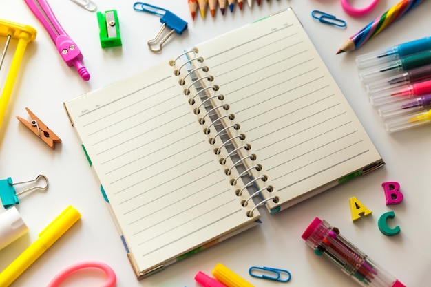 Blank notebook with School office supplies on a desk with copy space