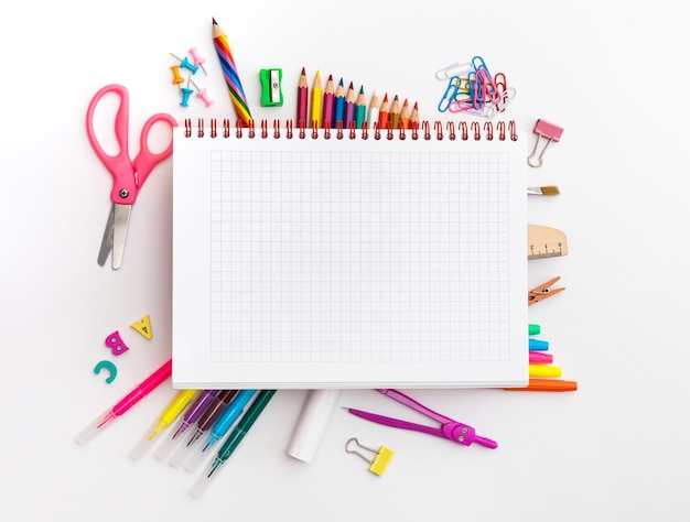 Blank notebook with School office supplies on a desk with copy space