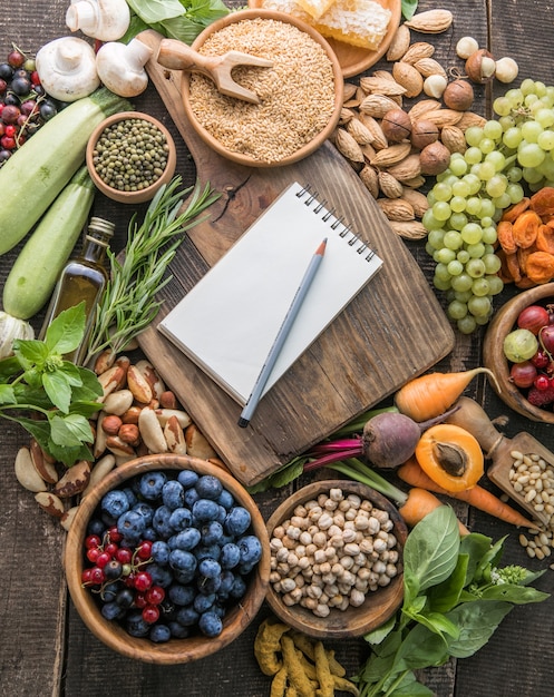 Blank notepad for copy space and  food ingredients on wooden table