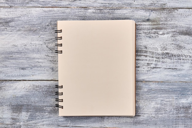 Blank notepad for copy space on gray wooden desk top view flat lay