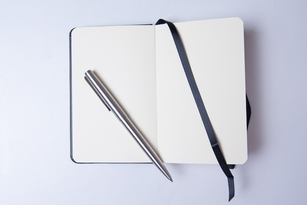 Blank notepad on white table ready to write