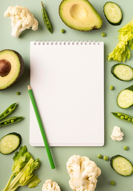 Blank notepad with ingredients for preparing tasty and healthy food