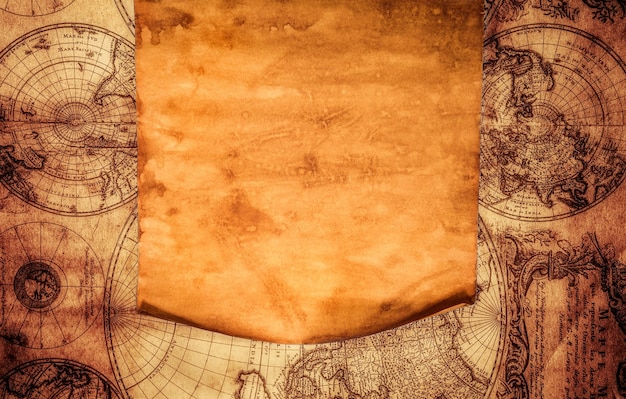 Blank old paper with curled edge against the background of an ancient map