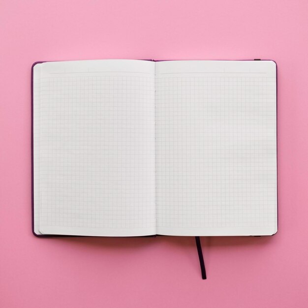 Blank open notebook with blank white pages on pink background flat lay