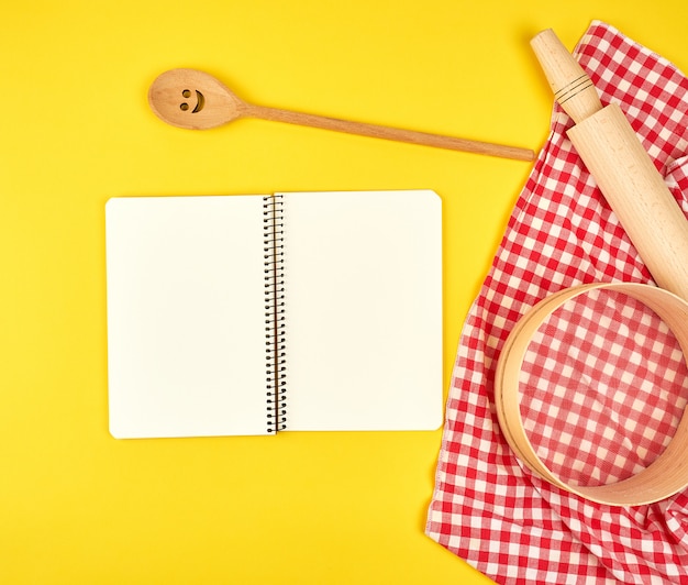 Blank open notebook and wooden kitchen accessories