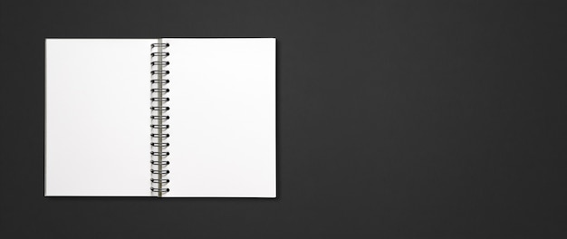 Blank open spiral notebook mockup isolated on black horizontal banner