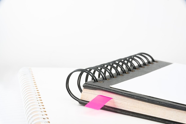 Blank opened spiral notebook placed on a table empty open notepad on top of a desk