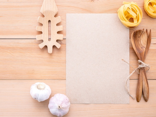 Blank paper, garlic and pasta lay flat