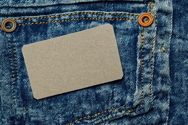 Photo blank paper label on a blue jeans texture