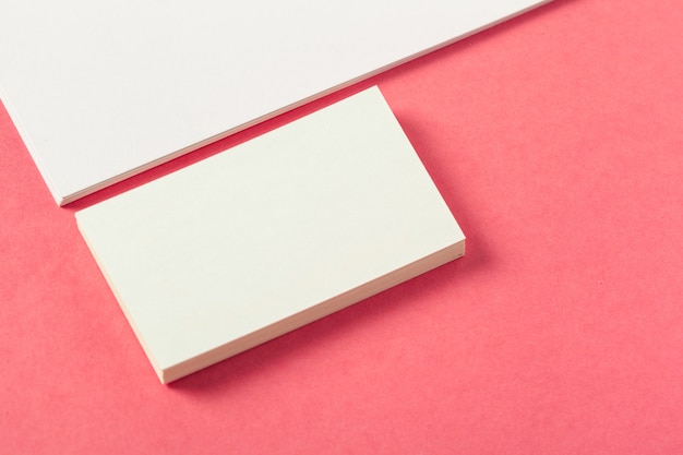 Blank paper pieces  on a colored pink background