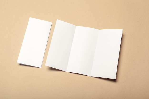 Blank paper pieces for mock up on a beige background