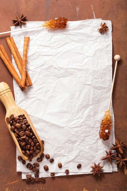 Blank paper for recipes over wooden table with coffee and spices