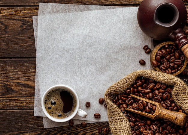 Blank paper sheet copy space over rustic coffee background with wood texture freshly brewed aromatic