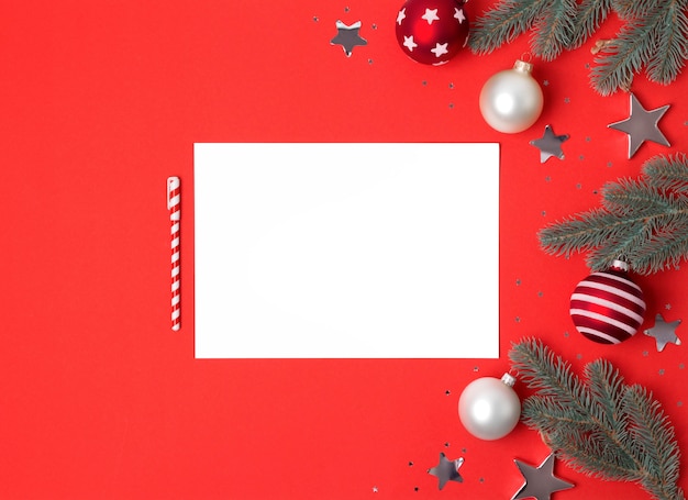 Blank paper sheet with Christmas decoration, top view