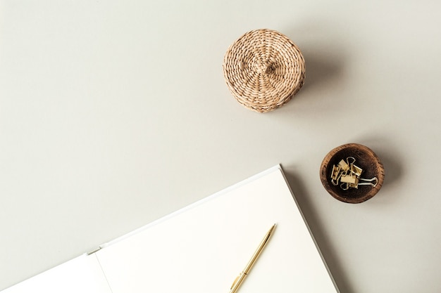 Blank paper sheets with empty copy space for text, pen, straw casket, clips on beige