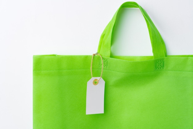 Blank paper tag with shopper paperbag on white background