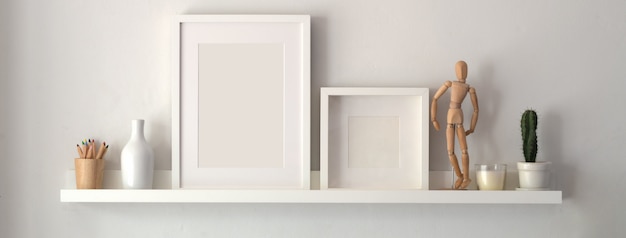 Blank photo frame and decorations on shelf with white wall 