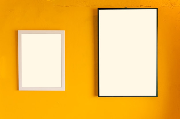 Blank photo frame on the yellow vintage wall