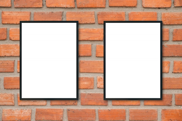 Blank poster picture frame on brick wall.