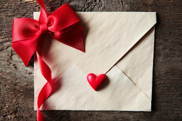 Blank present Valentine envelope on wooden background